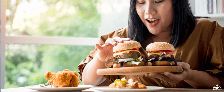 HHRC-Hungry overweight woman holding hamburger