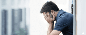 HHRC-Young man at balcony in depression suffering emotional crisis and grief